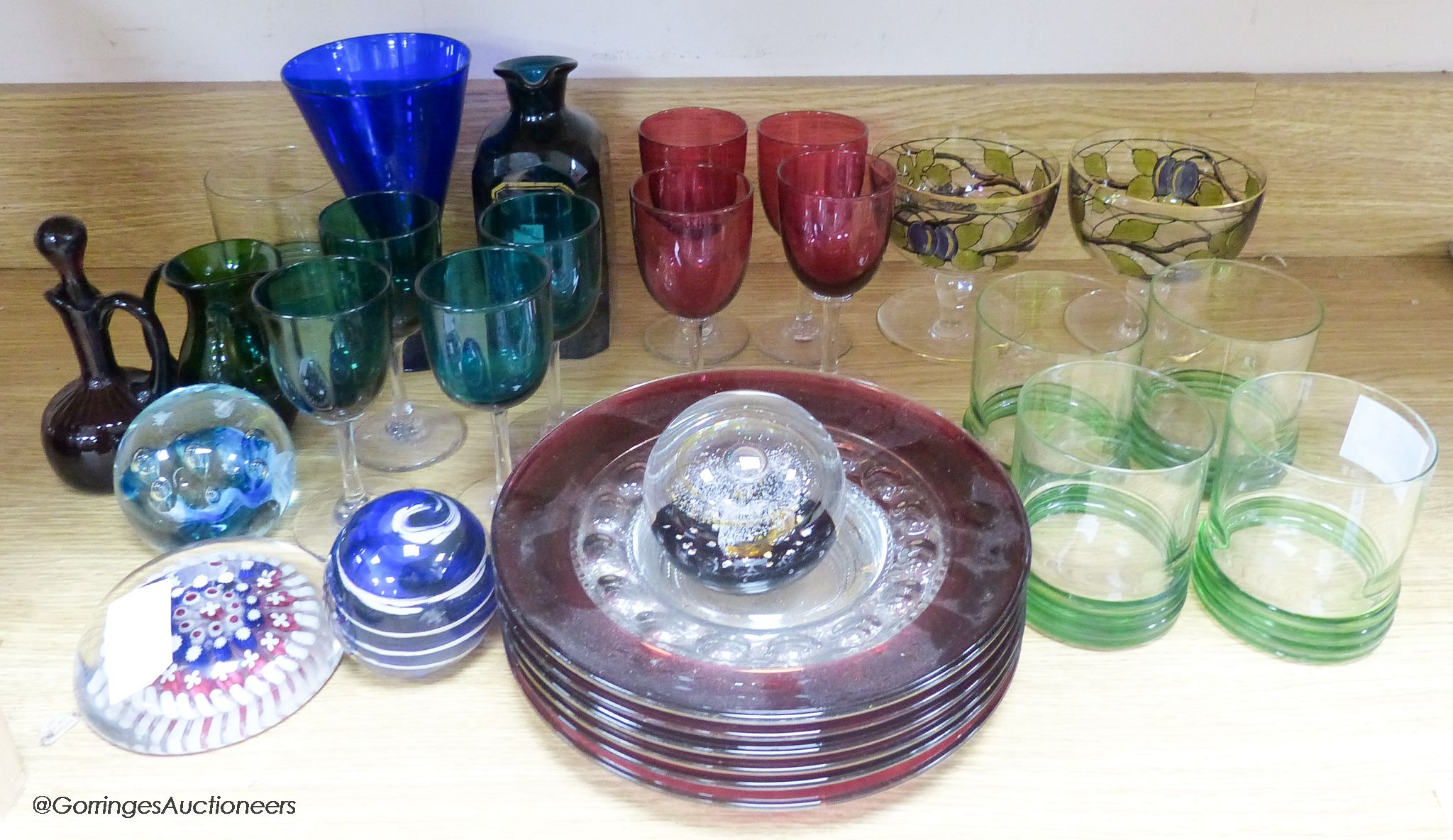 A quantity of mixed coloured glass and paper weights